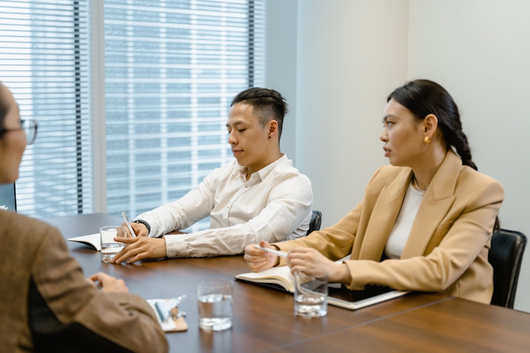 A group of people sitting around a table Description automatically generated with medium confidence