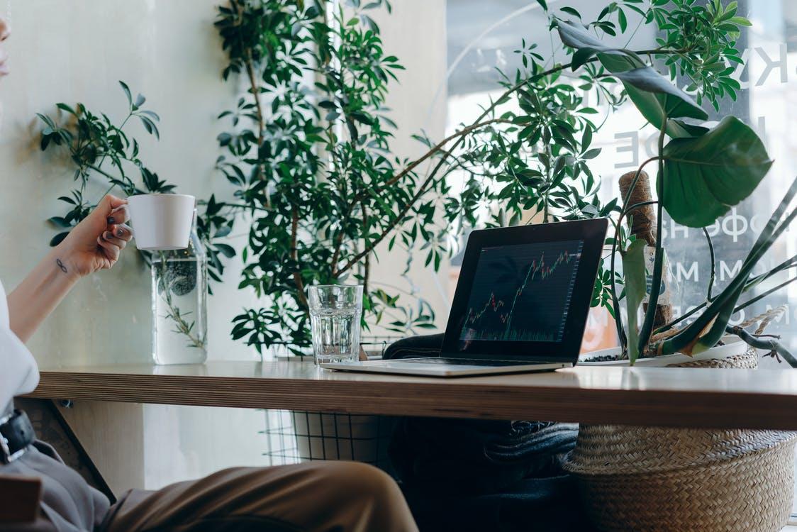 Free A MacBook on Brown Wooden Desk Stock Photo