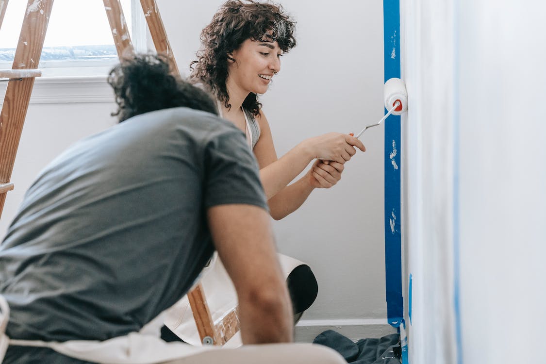 Free Woman Painting The Wall Stock Photo